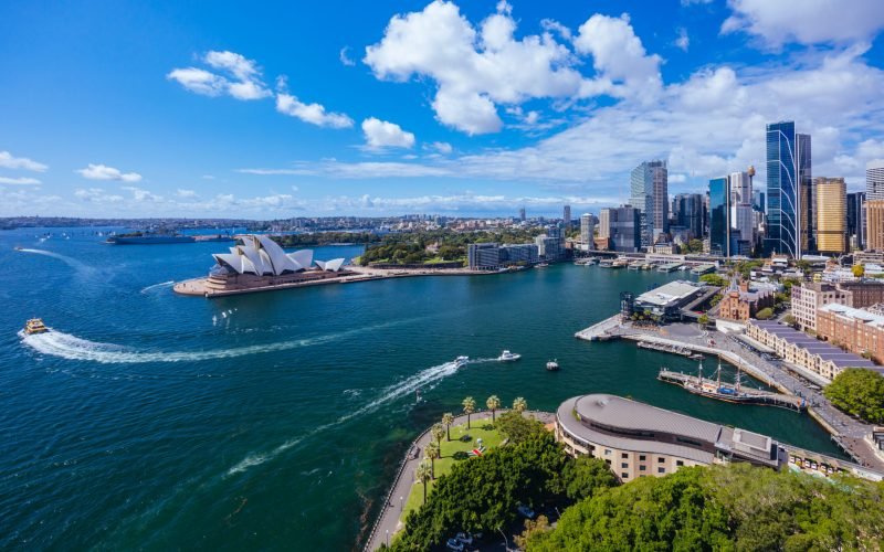 SYDNEY, AUSTRALIA - MARCH 4 2023: The Sydney CBD and surrounding harbour, including Circular Quay and The Rocks on a clear autumn day in Sydney, Australia